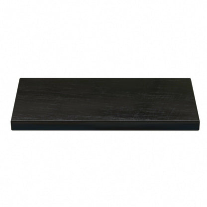 Angled view of black scratch stone showcasing its textured testing surface with a white background