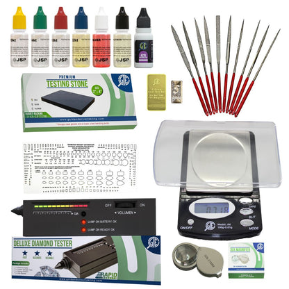 gold, silver, test kit, with diamond tester, scale, and needles on a white background.