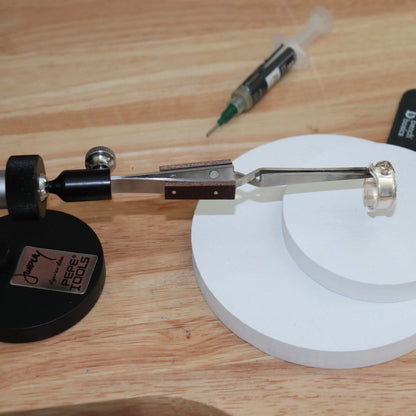 Side view of Whaley Adjustable Third Hand showing its clamp and holding arm on a wooden workbench