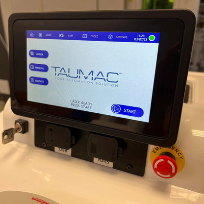 Front view of Tauweld 225J benchtop laser welder showcasing touchscreen controls and emergency stop button with workshop background