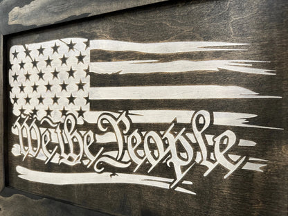 Close-up of the American Flag cabinet showcasing the We the People engraving and contrasting flag design on a dark wood panel