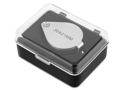 Angled view of 30X eye loupe magnifier in a protective black case with 30X21MM marking on white background