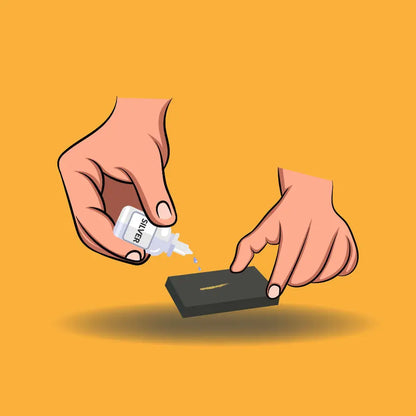 Hands applying silver testing solution to a scratch stone