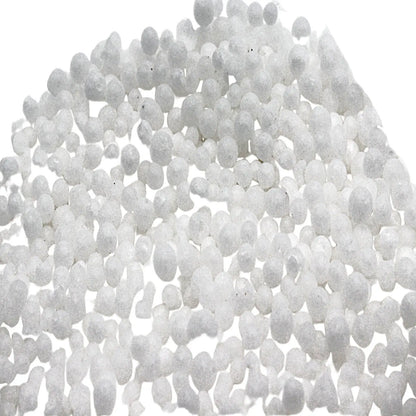 Close-up of JSP and GTE Urea 8 oz showcasing white 99 percent pure prilled granules on a white background