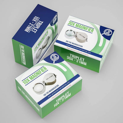 Angled view of 10X and 30X triplet magnifiers labeled 21MM in boxes on a gray background