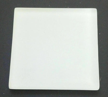 Close-up of a PuriTEST white test stone for the JSP precious metals testing kit on a dark background