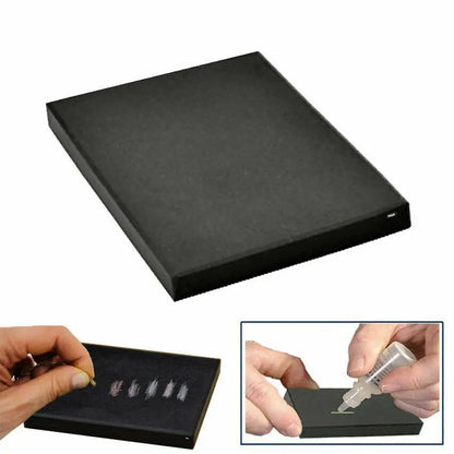 Angled view of PuriTEST gold and silver testing kit showcasing black testing stone and acid testing demonstration on white background