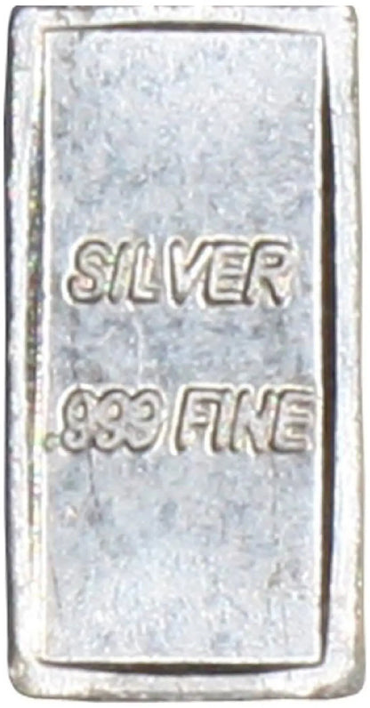 Close-up of a .999 fine silver bullion bar showing SILVER and .999 FINE markings within a raised border