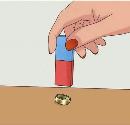 Hand holds a red and blue magnet above a gold ring to demonstrate jewelry testing