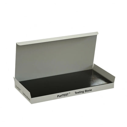 Front view of PuriTEST testing stone showcasing a black scratch surface in an open white box