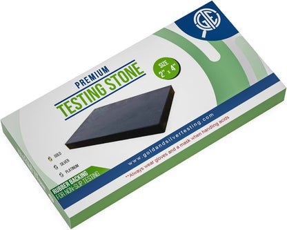 Angled view of premium testing stone box with black two by four inch stone and nonslip rubber backing on white background