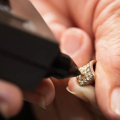 Close-up of GTE Deluxe Diamond and Gemstone Tester probing a gemstone ring